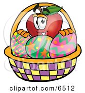 Red Apple Character Mascot In An Easter Basket Full Of Decorated Easter Eggs