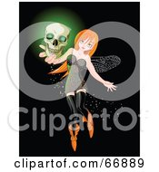 Sexy Red Head Halloween Fairy Holding A Glowing Skull