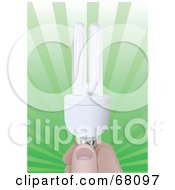 Poster, Art Print Of Hand Holding A Compact Energy Efficient Light Bulb Over A Green Burst