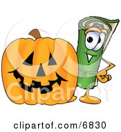 Green Carpet Mascot Cartoon Character With A Carved Halloween Pumpkin