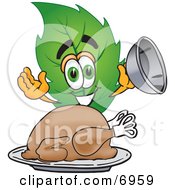 Leaf Mascot Cartoon Character Serving A Thanksgiving Turkey On A Platter by Mascot Junction