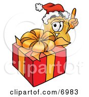 Badge Mascot Cartoon Character Standing By A Christmas Present