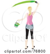 Rear View Of A Caucasian Woman Holding A Bucket And Painting A Slash Of Green Paint On A Wall