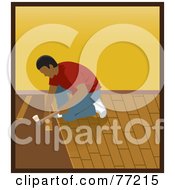 Hispanic Man Kneeling And Hammering While Installing Wood Floors