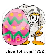 Chefs Hat Mascot Cartoon Character Standing Beside An Easter Egg