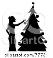 Poster, Art Print Of Silhouette Of A Woman Hanging Ornaments On Her Christmas Tree