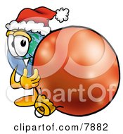 World Earth Globe Mascot Cartoon Character Wearing A Santa Hat Standing With A Christmas Bauble by Toons4Biz