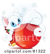 Cute White Christmas Kitten Curled Up On A Red Bauble