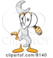 Wrench Mascot Cartoon Character Looking Through A Magnifying Glass
