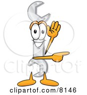 Clipart Picture Of A Wrench Mascot Cartoon Character Waving And Pointing by Mascot Junction