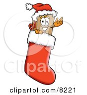 Clipart Picture Of A Cardboard Box Mascot Cartoon Character Wearing A Santa Hat Inside A Red Christmas Stocking by Toons4Biz