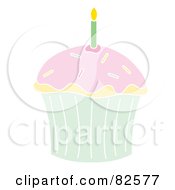 Green Birthday Candle In A Vanilla Cupcake With Pink Frosting And Sprinkles
