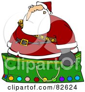 Santa Wearing A Stash Of Jingle Bells And Standing In A Giant Green Christmas Gift Bag