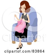 Pleasant Brunette Caucasian Woman Sitting In A Chair And Sewing