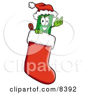 Dollar Bill Mascot Cartoon Character Wearing A Santa Hat Inside A Red Christmas Stocking by Toons4Biz