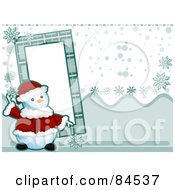 Poster, Art Print Of Christmas Snowman In A Santa Suit By A Frame Over A Snowy Background