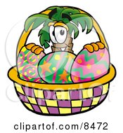 Palm Tree Mascot Cartoon Character In An Easter Basket Full Of Decorated Easter Eggs