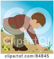 Brunette Caucasian Boy On A Beach Bending Over To Pick Up A Shell