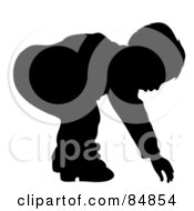 Poster, Art Print Of Silhouetted Boy Bending Over To Reach For Something