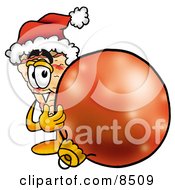 Slice Of Pizza Mascot Cartoon Character Wearing A Santa Hat Standing With A Christmas Bauble by Mascot Junction