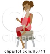Pretty Hispanic Woman Sitting On A Stool And Painting Her Toes During A Home Pedicure