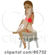 Hispanic Woman Sitting On A Stool And Shaving Her Legs