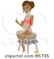Hispanic Woman Sitting On A Stool And Waxing Her Legs