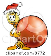 Broom Mascot Cartoon Character Wearing A Santa Hat Standing With A Christmas Bauble