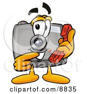 Camera Mascot Cartoon Character Holding A Telephone