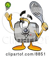 Camera Mascot Cartoon Character Preparing To Hit A Tennis Ball