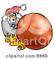 Camera Mascot Cartoon Character Wearing A Santa Hat Standing With A Christmas Bauble by Mascot Junction