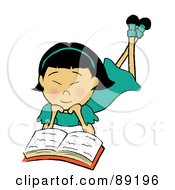 Asian Girl Laying On Her Belly And Reading A Book
