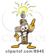 Wooden Cross Mascot Cartoon Character With A Bright Idea