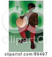 African Man Sitting And Playing A Tambourine