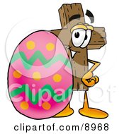 Wooden Cross Mascot Cartoon Character Standing Beside An Easter Egg