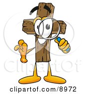 Wooden Cross Mascot Cartoon Character Looking Through A Magnifying Glass