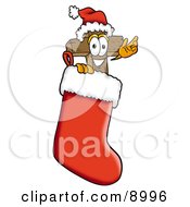 Clipart Picture Of A Wooden Cross Mascot Cartoon Character Wearing A Santa Hat Inside A Red Christmas Stocking by Toons4Biz