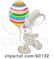 Royalty Free RF Clipart Illustration Of A Gray Easter Bunny Holding Up A Striped Egg