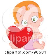 Cute Baby Sucking Her Thumb And Holding A Heart