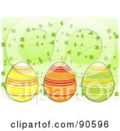 Royalty Free RF Clipart Illustration Of A Trio Of Painted Easter Eggs Over A Background Of Clovers On Green
