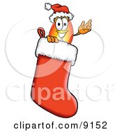 Flame Mascot Cartoon Character Wearing A Santa Hat Inside A Red Christmas Stocking by Mascot Junction