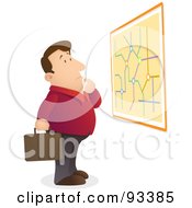 Lost And Confused Businessman Reading A Map On A Wall
