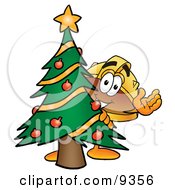 Poster, Art Print Of Hard Hat Mascot Cartoon Character Waving And Standing By A Decorated Christmas Tree