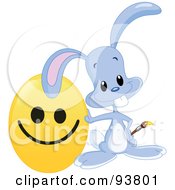 Poster, Art Print Of Cute Blue Easter Bunny Leaning On A Happy Face Easter Egg