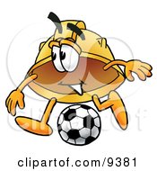 Hard Hat Mascot Cartoon Character Kicking A Soccer Ball