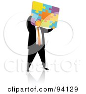 Orange Faceless Businessman Holding Up A Colorfup Puzzle