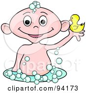 Caucasian Baby Holding Up A Rubber Duck In A Bubble Bath