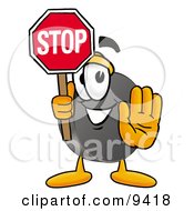 Hockey Puck Mascot Cartoon Character Holding A Stop Sign