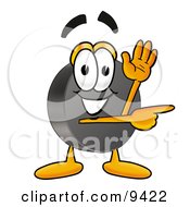 Hockey Puck Mascot Cartoon Character Waving And Pointing by Mascot Junction