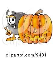 Hockey Puck Mascot Cartoon Character With A Carved Halloween Pumpkin